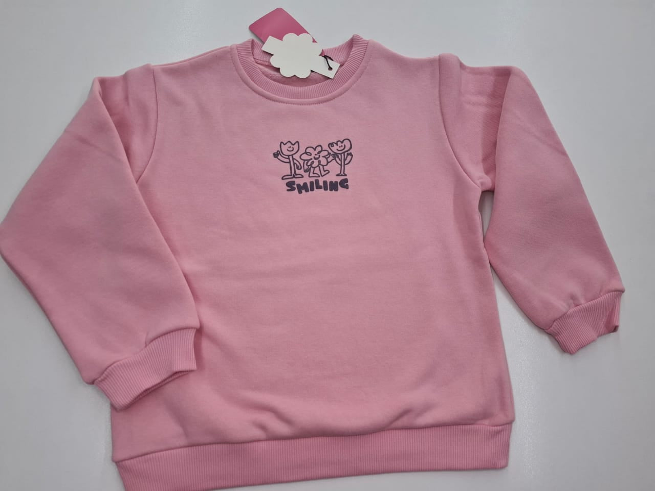 Whisper the Beauty: Pink Sweatshirt with Smiling Flowers Graphic